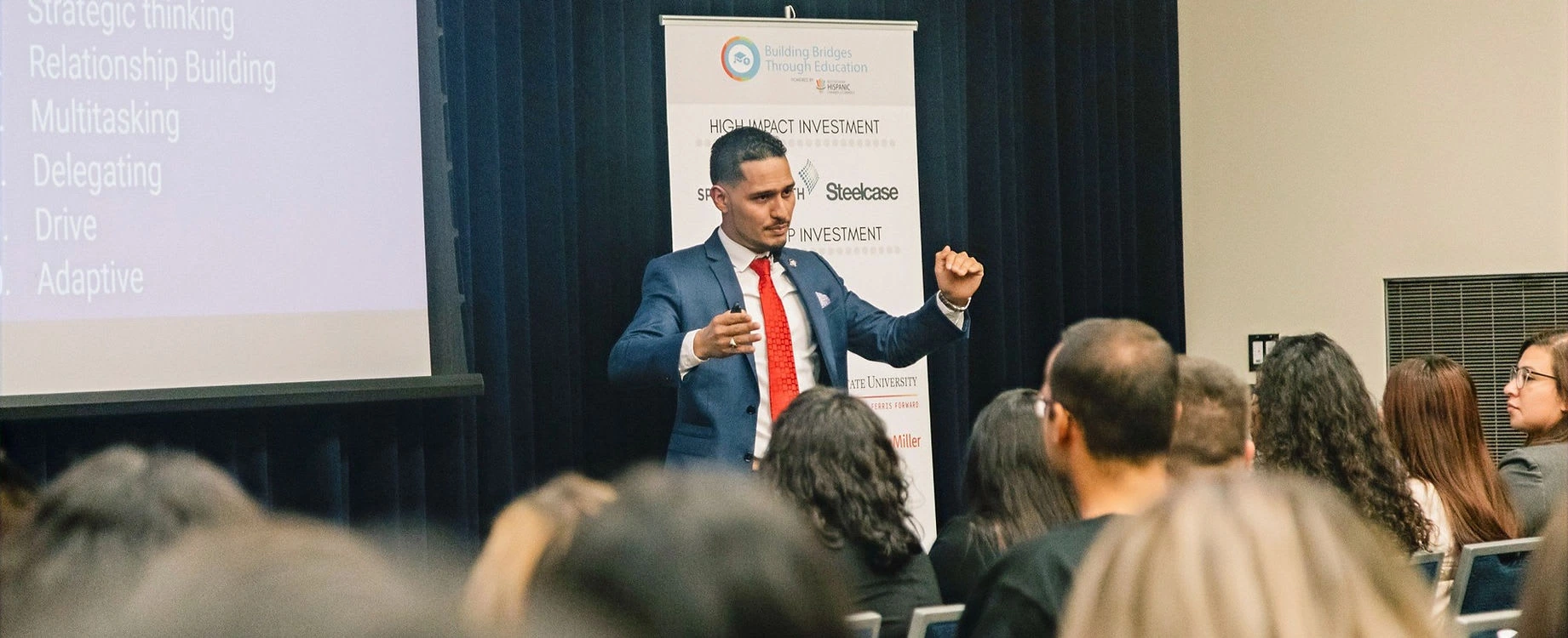 Ovi Vasquez speaking at a leadership event in front of an audience